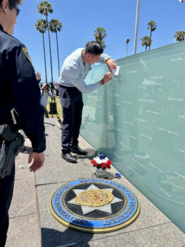 Man getting a memorial rubbing of Officer Craven's name