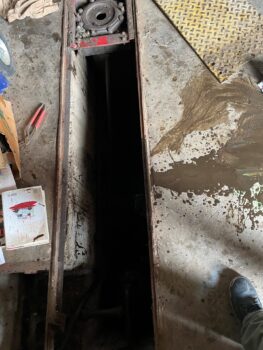 Oil well dog was trapped in under the floor of a garage