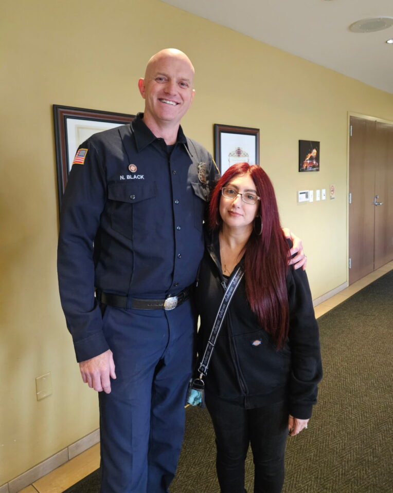 person stands next to paramedic in a hallway