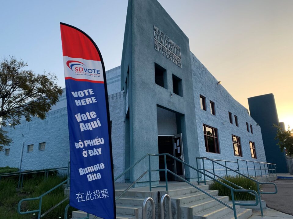exterior of Mid-City Community Gym with "Vote Here" sign