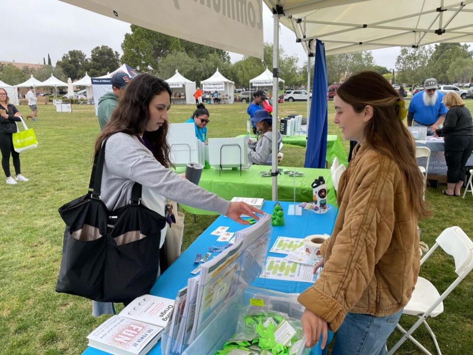Two people speak at the table at NAMIWalks San Diego