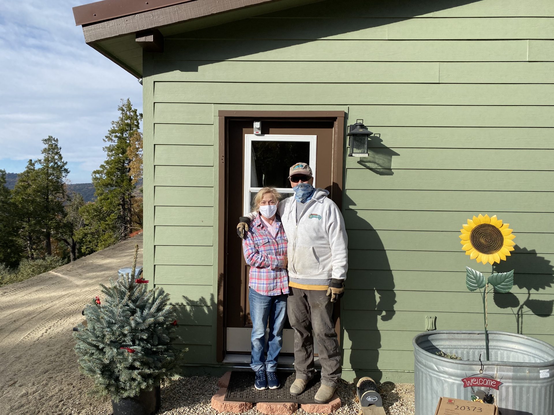 The Weir family stand by door with secure key safe on the front door.