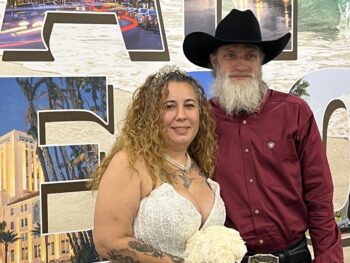 Couple puts arm around each other and smiles