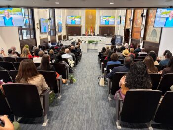 Audience from behind looking to speakers at the front of the room