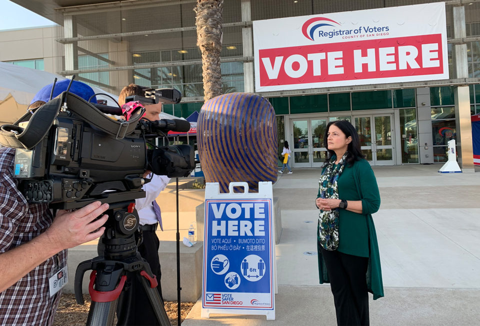Cynthia Paes being interviewed by media outside the Registrar of Voters