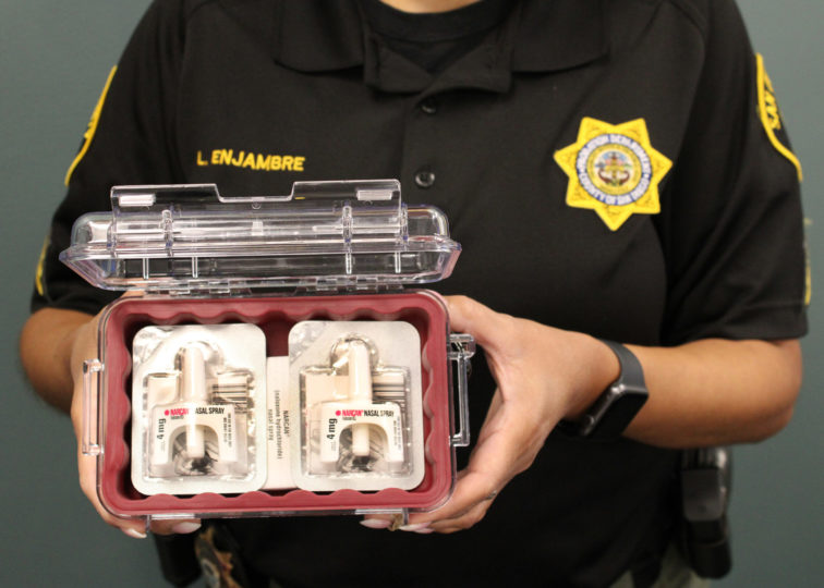 probation officer holding the naloxone they carry.