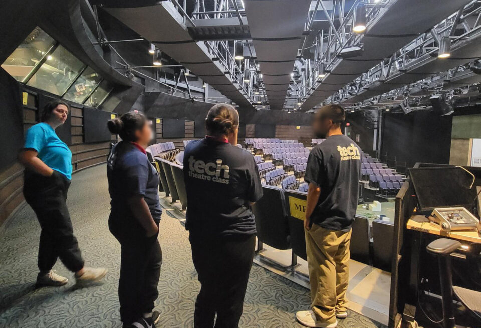 Theater students looking at lighting