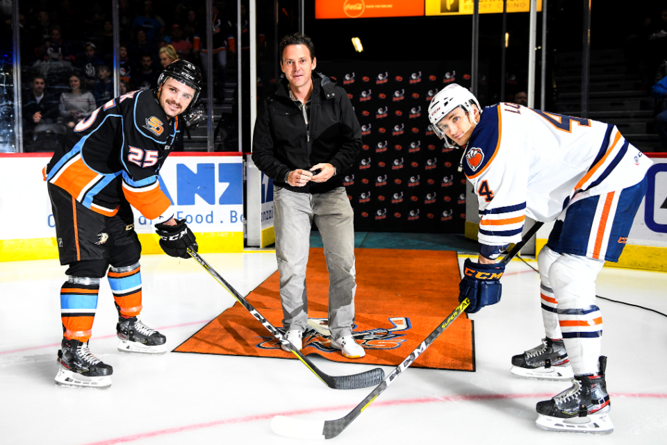 Two ice hockey players wait for the puck drop