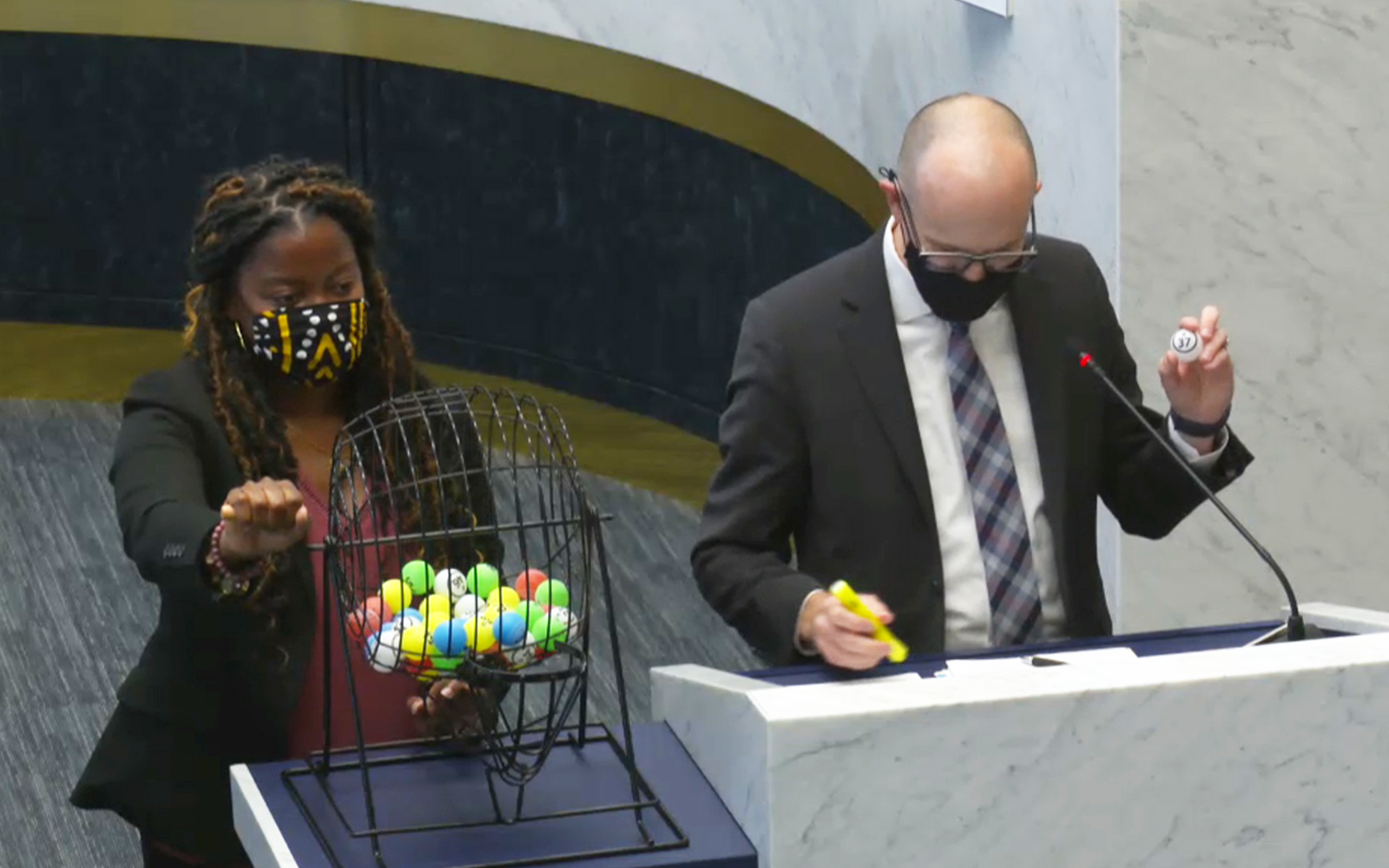 numbers are selected from a spinning wheel cage with numbered balls