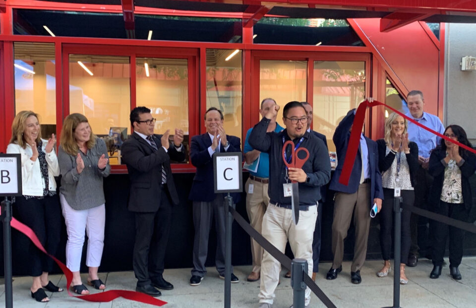 people cutting a ribbon