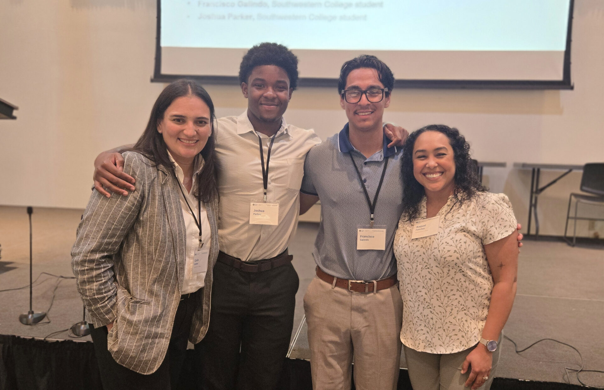 Two teen boys and Rising Scholars moderators