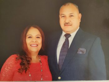 A couple smiles in a photo