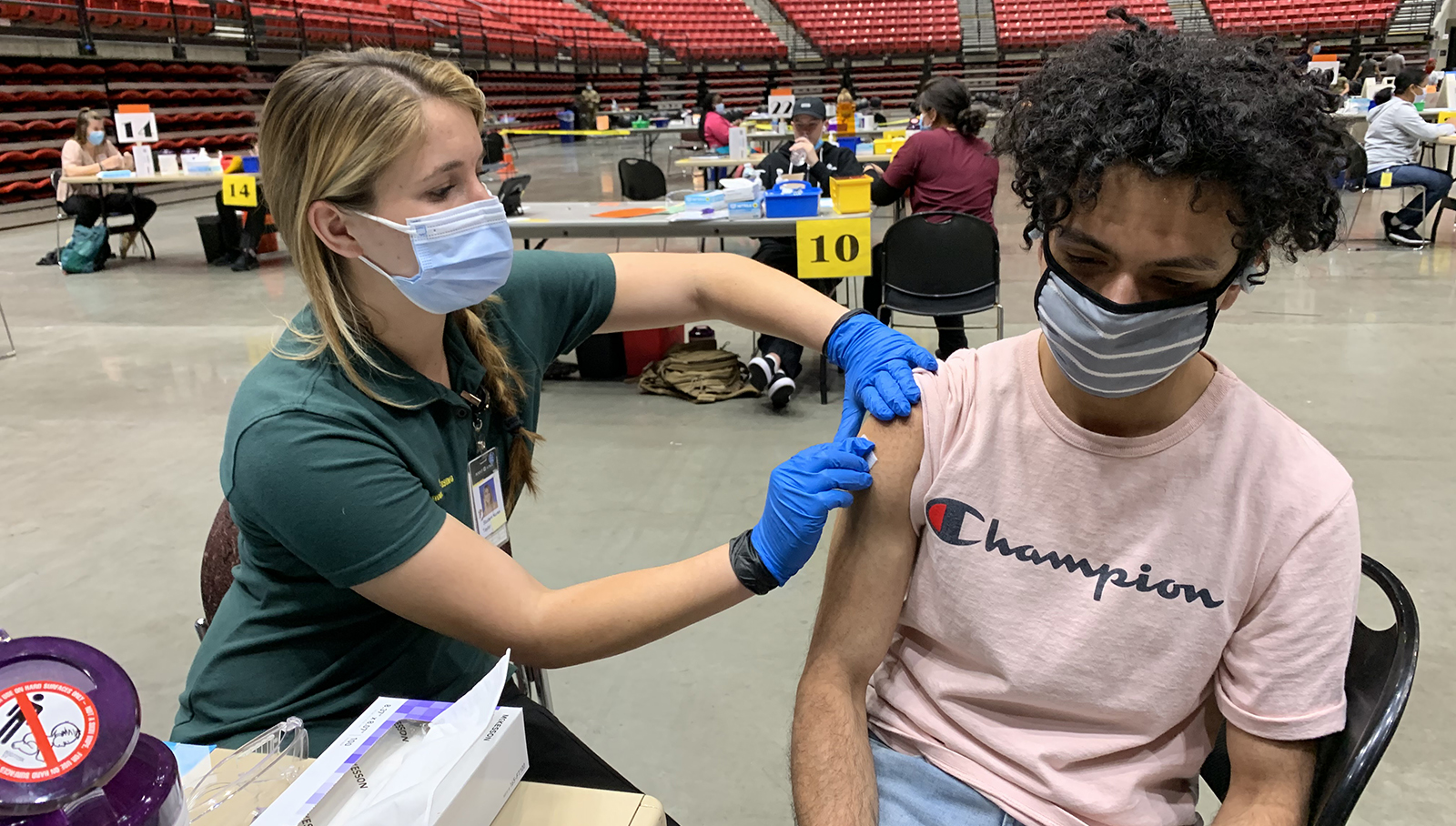 a young man gets a vaccine