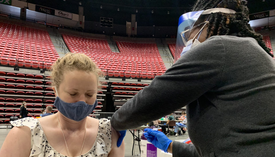 a young woman gets a vaccine