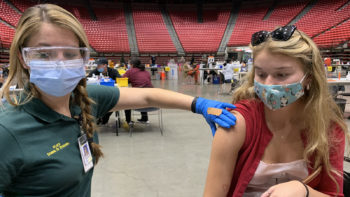 a young woman gets a vaccination