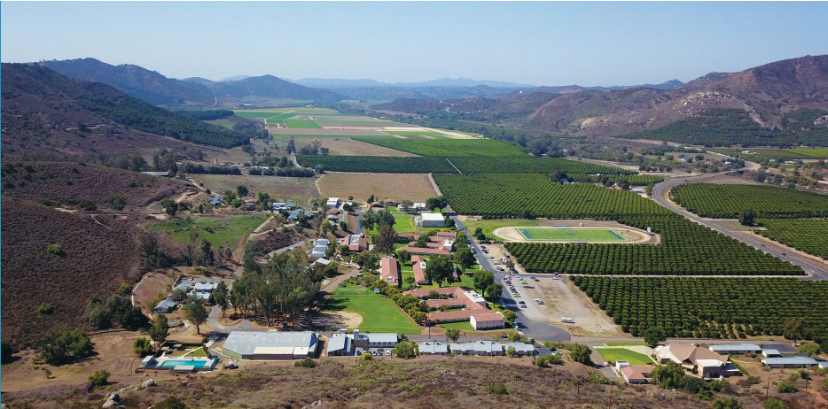 mountains with farmland and buildings