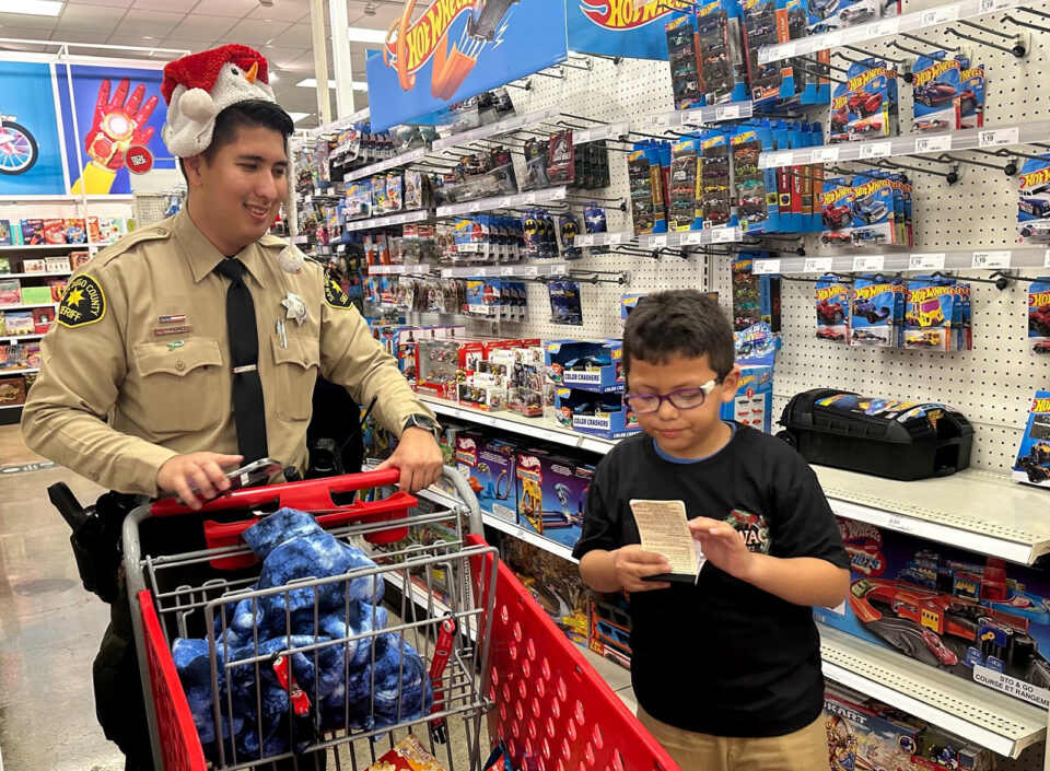 Deputy shopping with boy