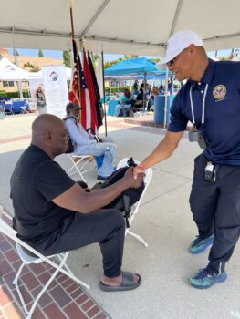 Volunteer shaking hands with veteran