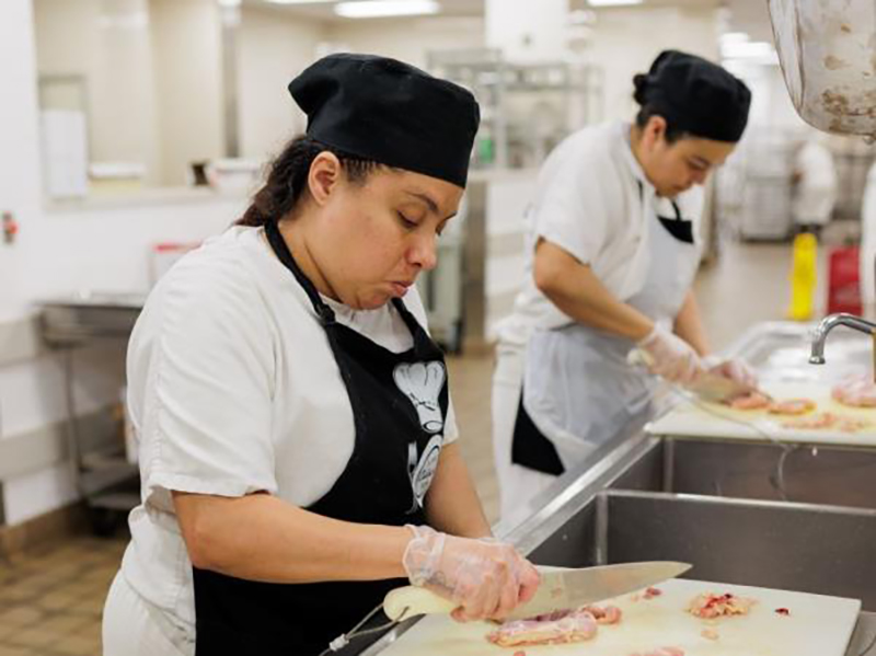 Reetry participants chopping food