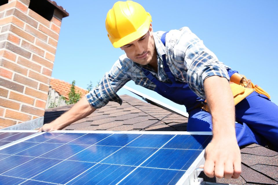 Man installing solar panels