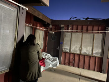 a person stands near a building