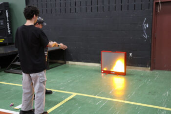 Student learning how to use a fire extinguisher