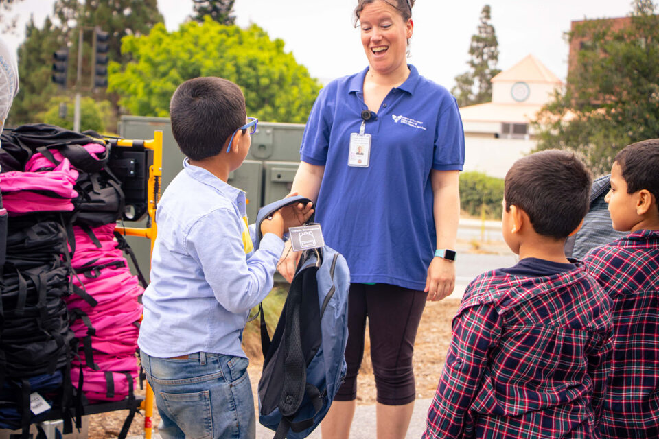 Child picks out a backpack for school at last year's Super Saturday event.