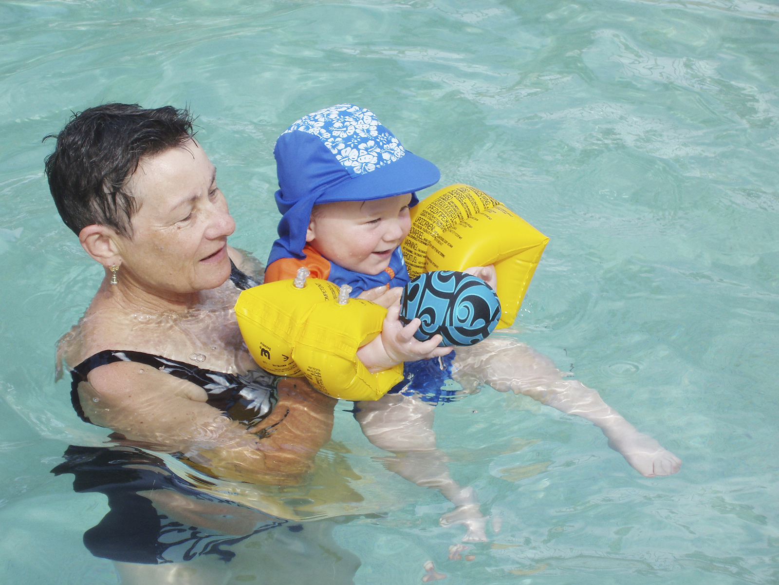 woman swimming with infant