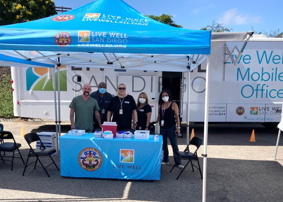 County Public Health team gather to provide vaccinations at event.