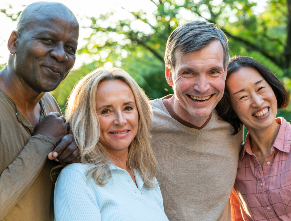 Four older adults smiling