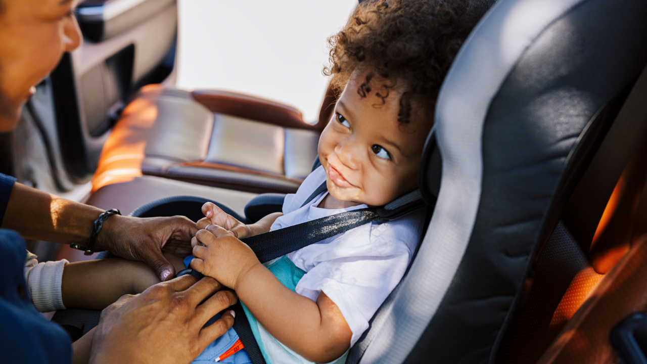 Smiling child in car seat