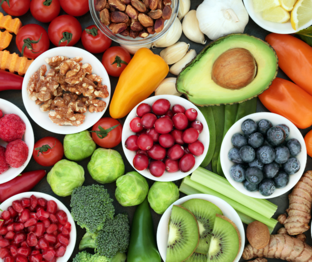 fruits and vegetables in small bowls on table
