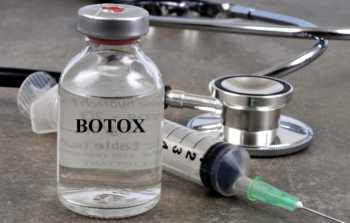 Botox in vial with syringe and stethoscope