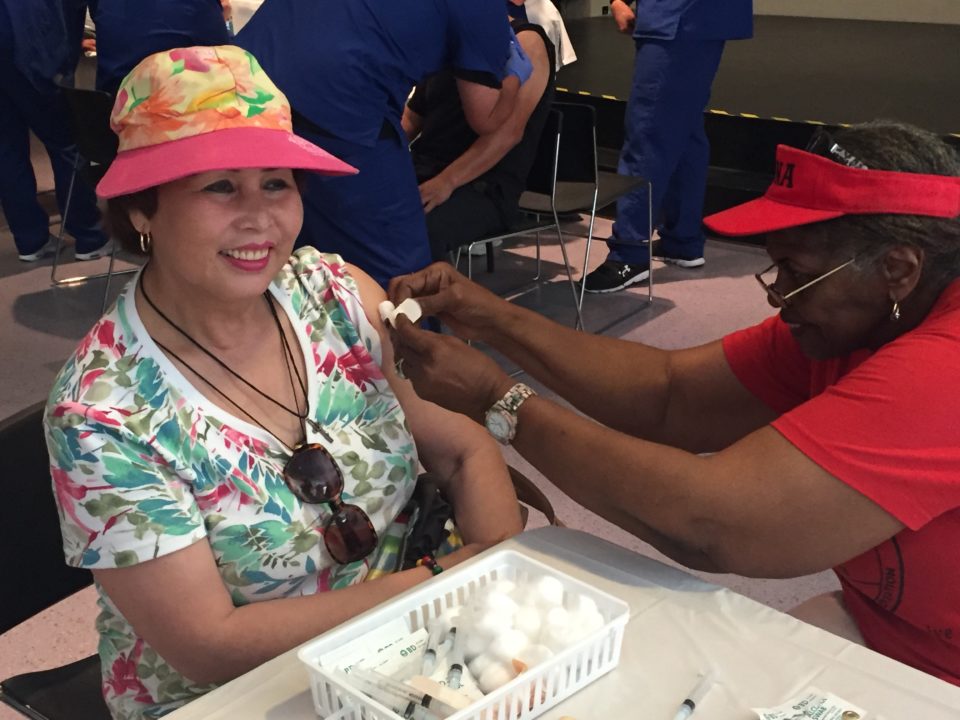 an older woman getting a flu shot