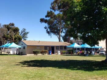 The outside of Golden Hill Community Clubhouse with pop up tents for vaccination event