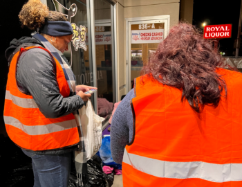 volunteers speaks with a person experiencing homelessness