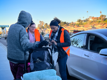 volunteers speaks with a person experiencing homelessness