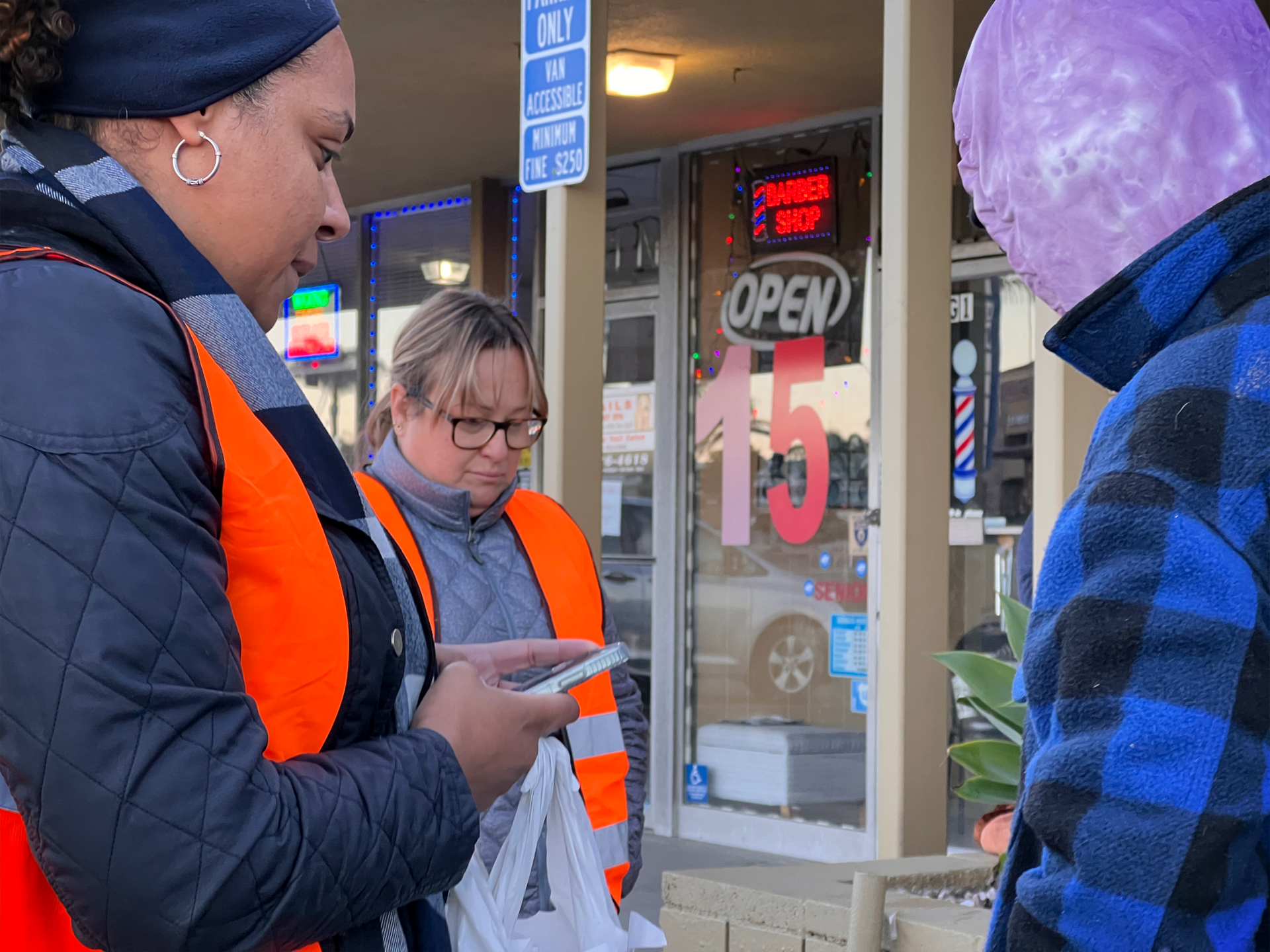 Point in Time Volunteers speak with person experiencing homelessness.
