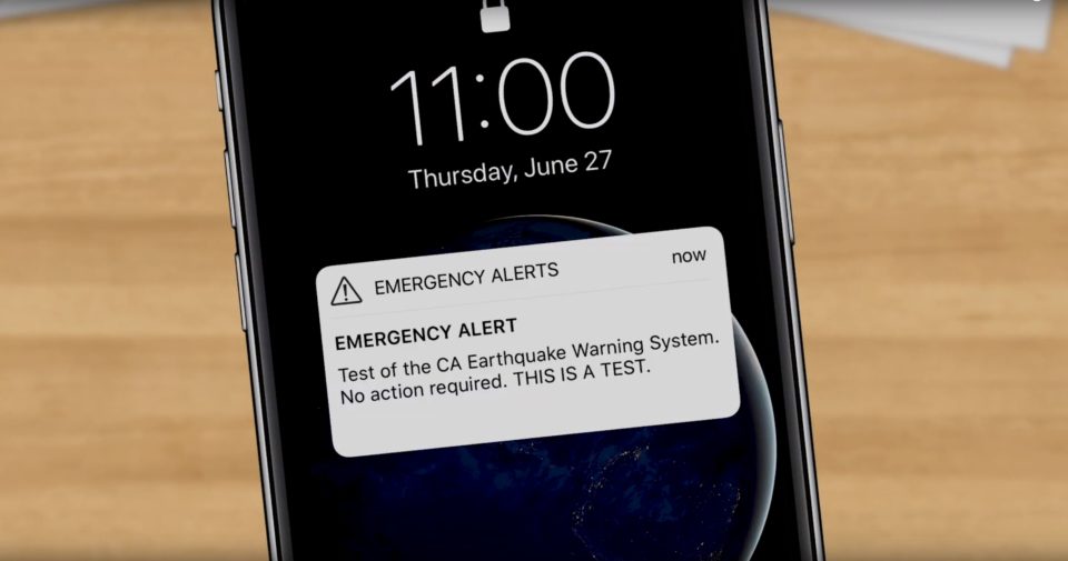 Photo of an iPhone with an Emergency Alert text.