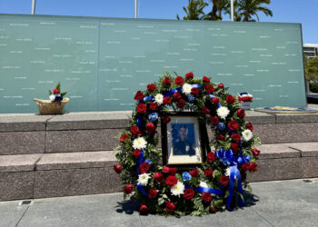 Wall of Light memorial with fresh wreath and fallen officer Craven's photo.