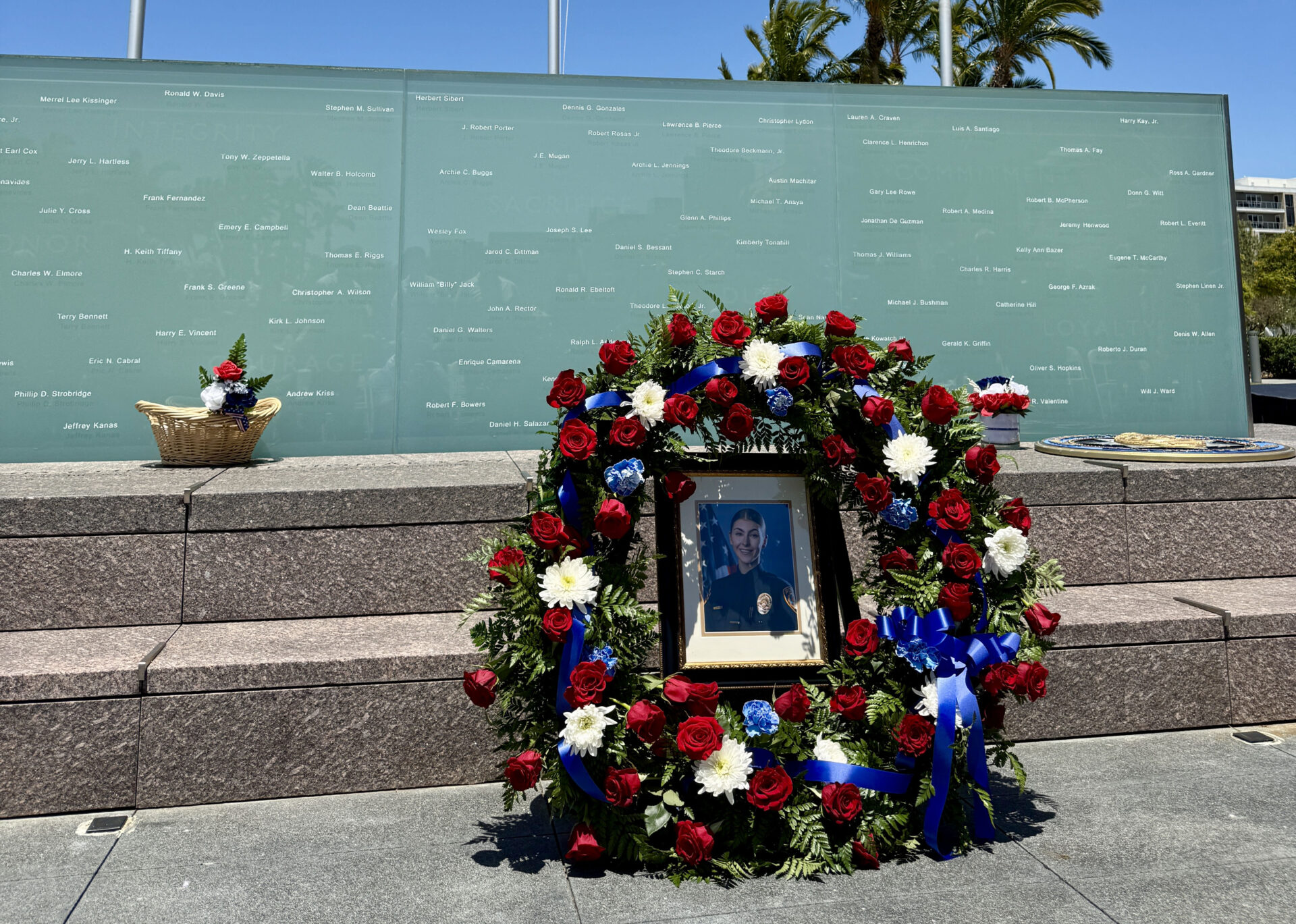 Wall of Light memorial with fresh wreath and fallen officer Craven's photo.