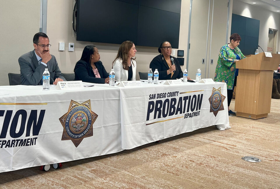 Four panelist speakers and a moderator at front of room.