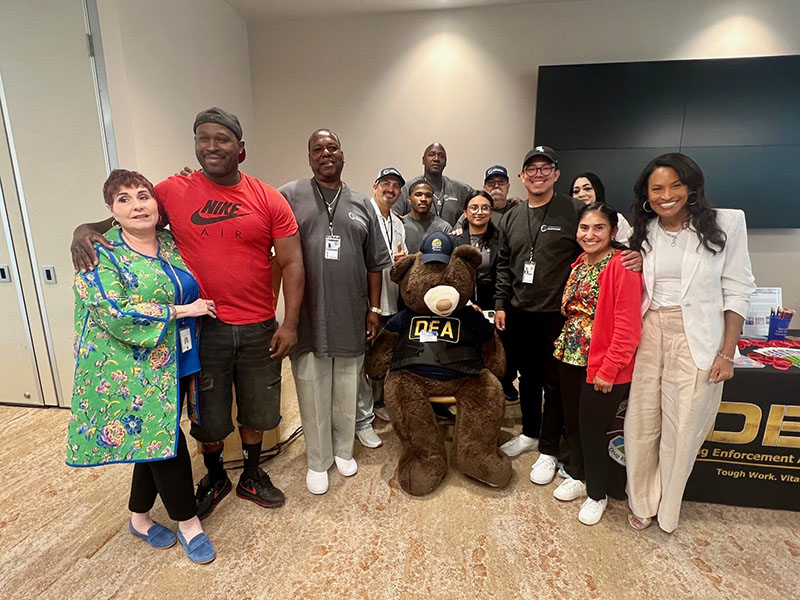 Youth Symposium attendees and Probation community partners posed for a photo with the DEA teddy bear.
