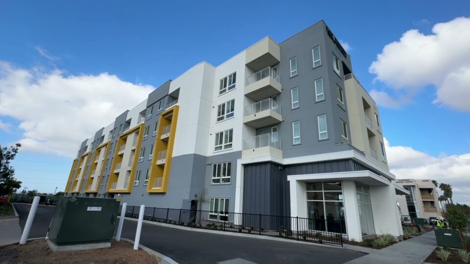 exterior of five-story building with clouds in the sky