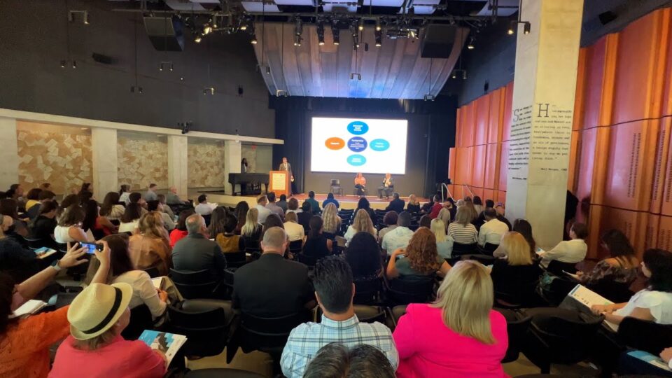 a room full of participants at a forum