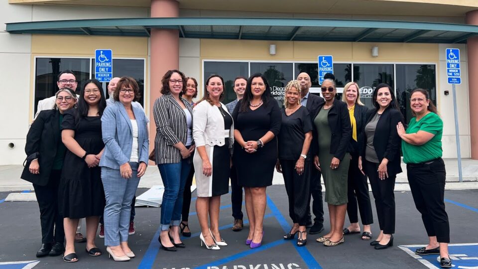 group stands outside facility