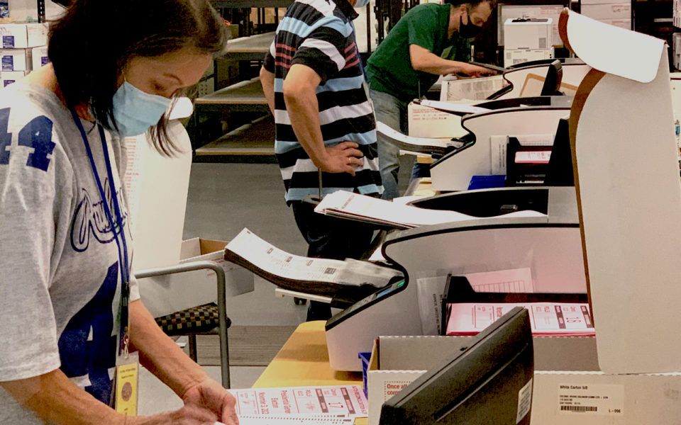 woman scanning ballots