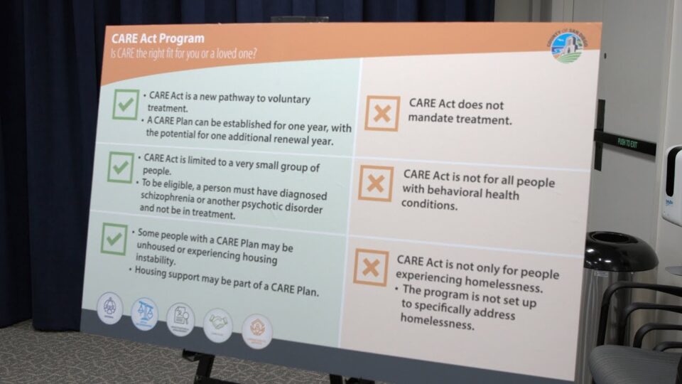 Poster about the CARE Act Program on an easle in a conference room