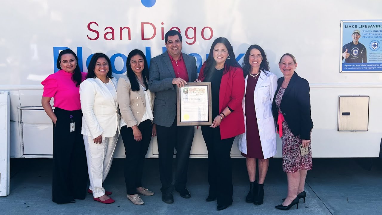Group stands in front of San Diego Blood Bank mobile