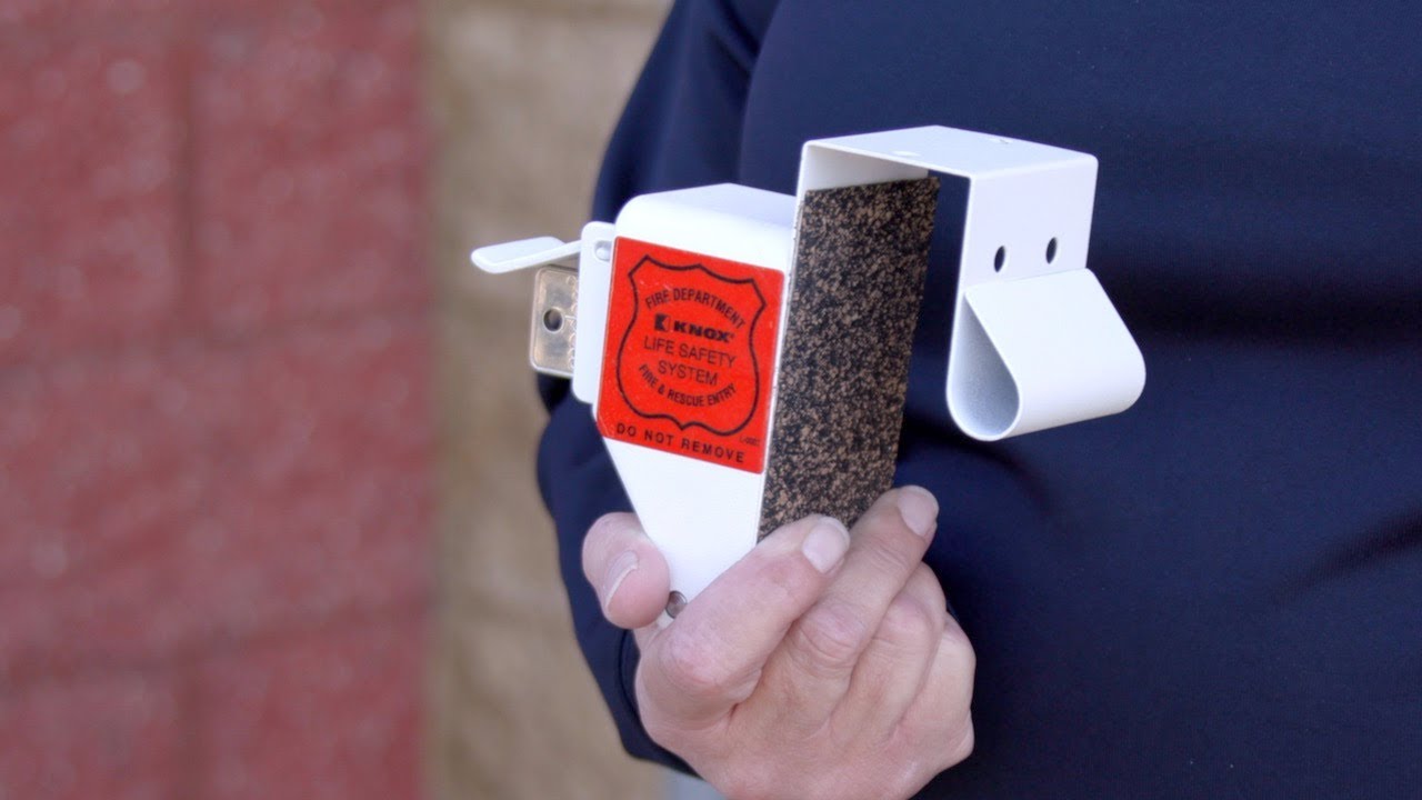 a man holds a knox box in his hand